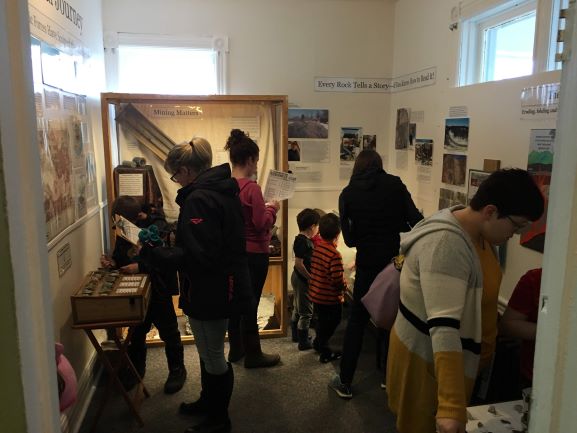 Guests look in the geology room for a hidden egg